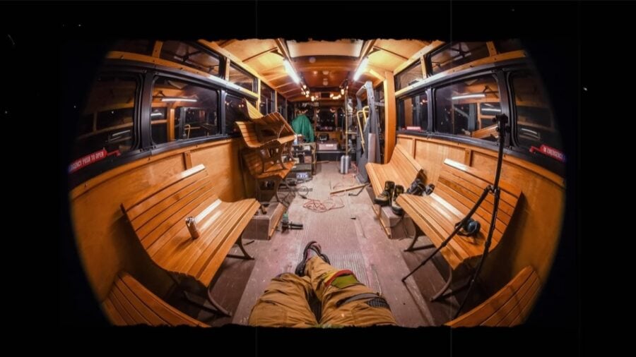 Historic trolley transformed into a cozy tiny home with wooden interiors and seating.