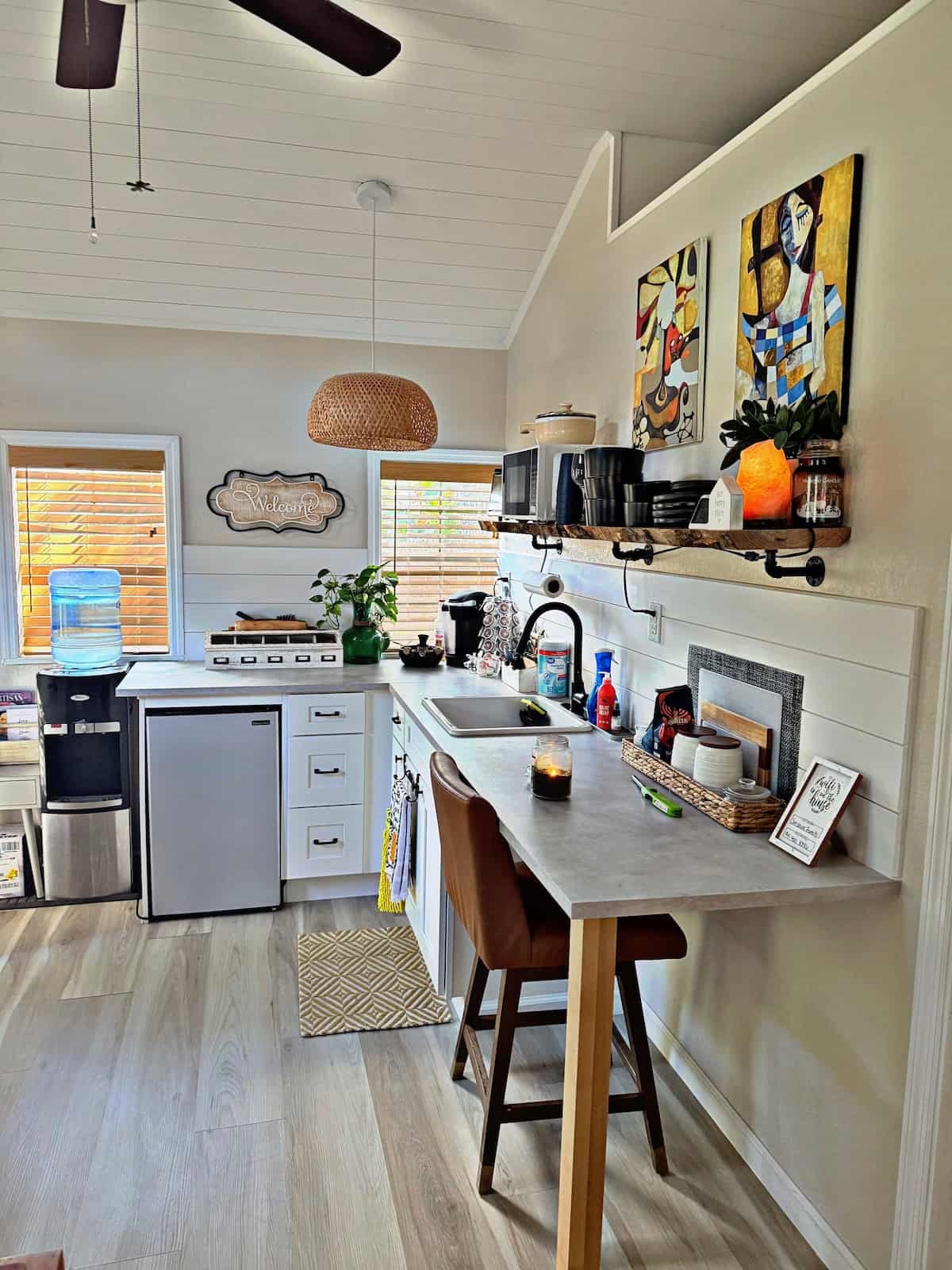 Compact tiny house kitchen with modern appliances and stylish decor.