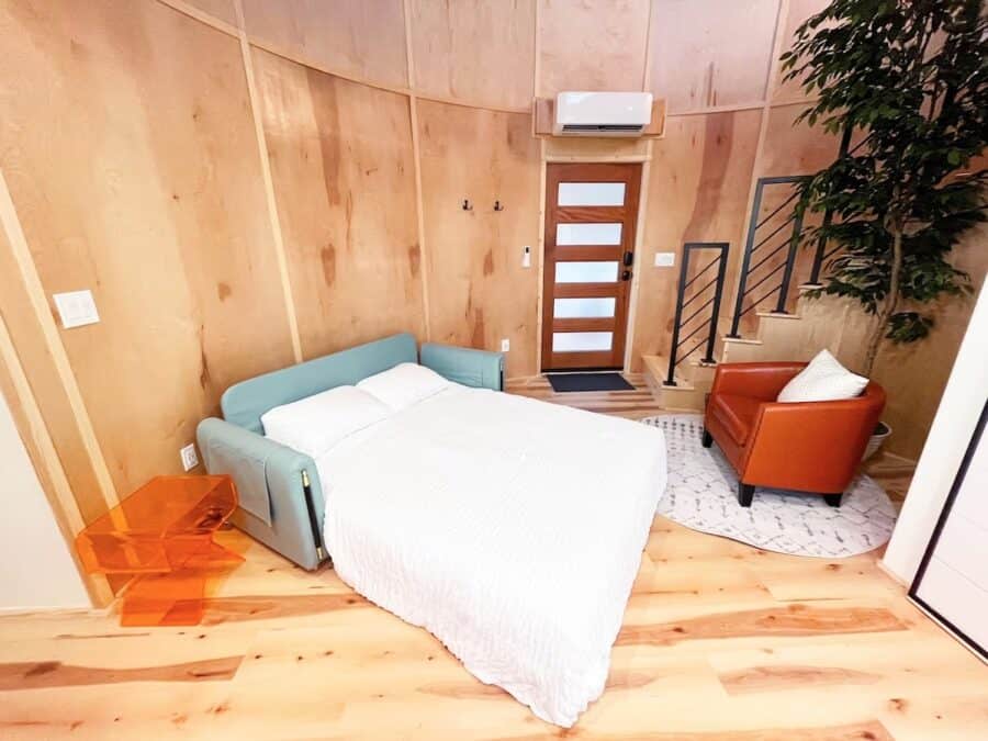 Charming bedroom in a Stargazing Cabin with wooden walls and modern decor in Springdale, Arkansas.