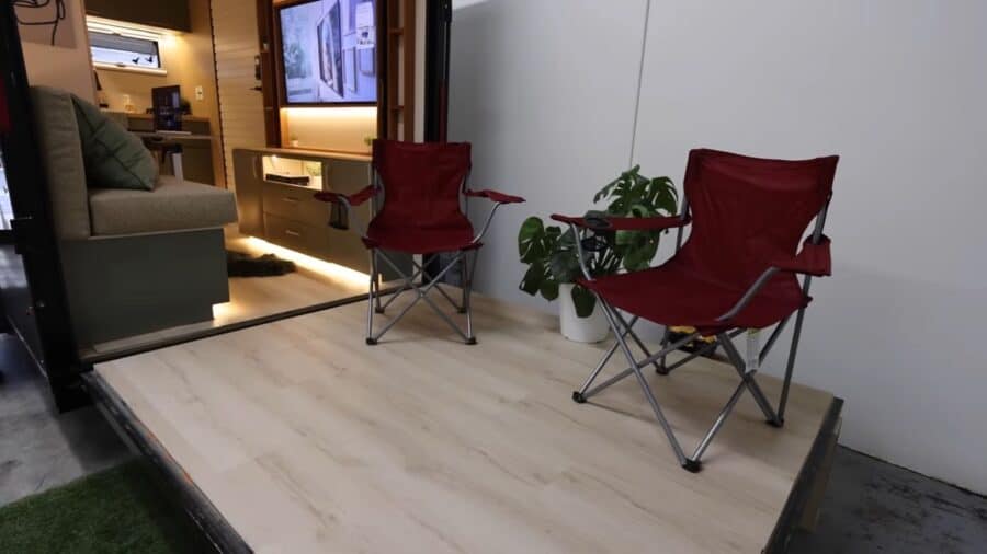 Cozy tiny house interior featuring two red foldable chairs and a potted plant.