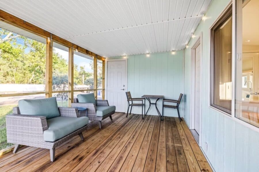 Charming tiny house porch with cozy seating and scenic views in Tampa, Florida. Perfect for relaxing.