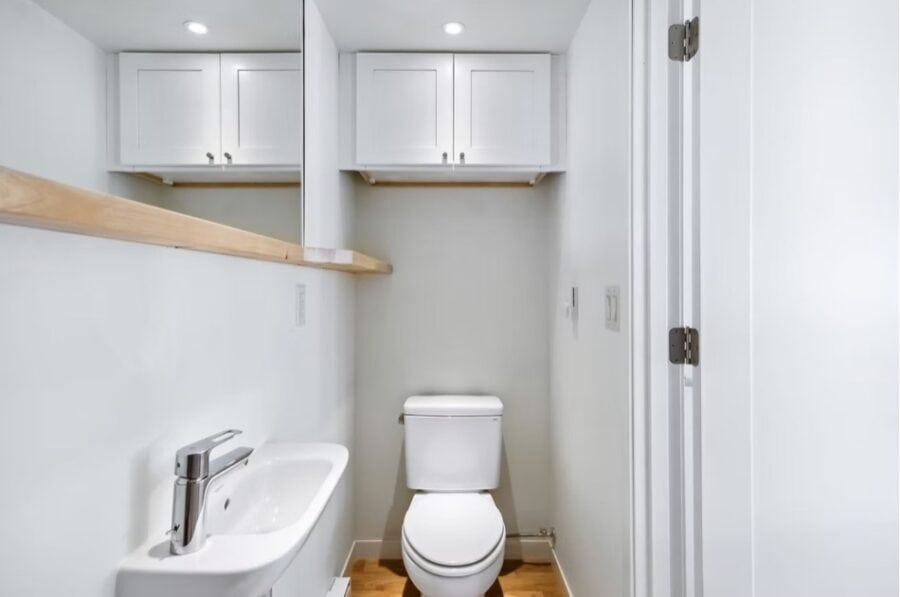 Compact tiny house bathroom with sink and toilet in stylish villa. Perfect for small space living in.
