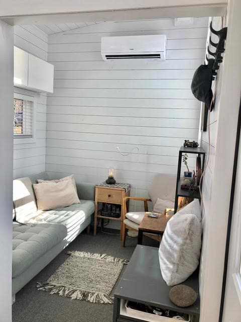 Airbnb-style tiny house interior with minimalist decor and compact furniture.