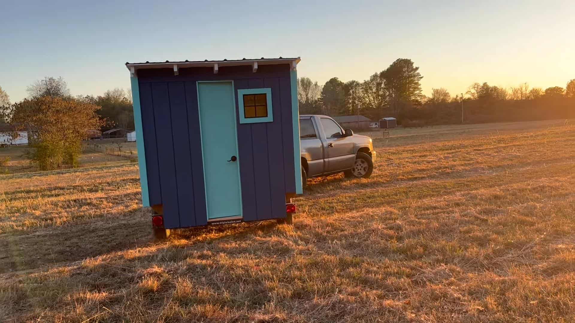 Tiny House with Blue Exterior and Small Window