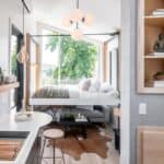 Bright tiny house interior featuring a cozy sleeping area, minimalist decor, and large windows for n.