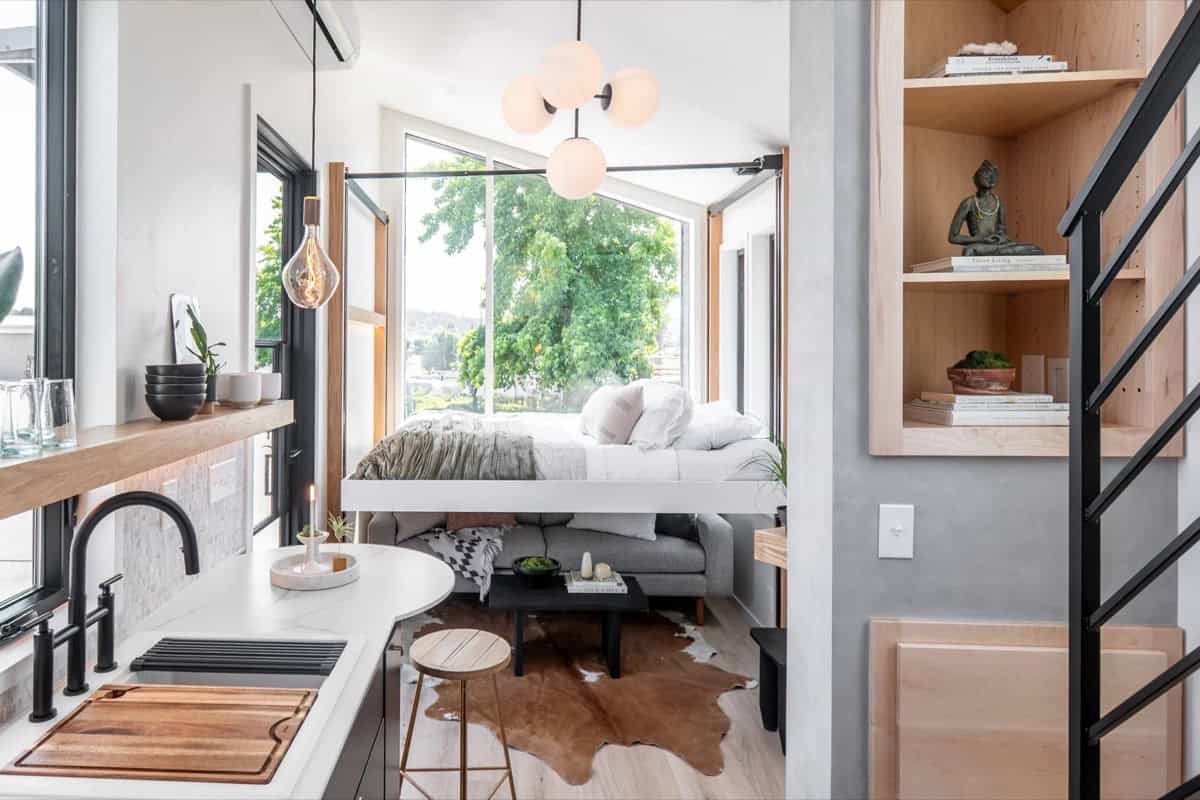 Motorized elevator bed lowered over the living room in the Terra Urban tiny house