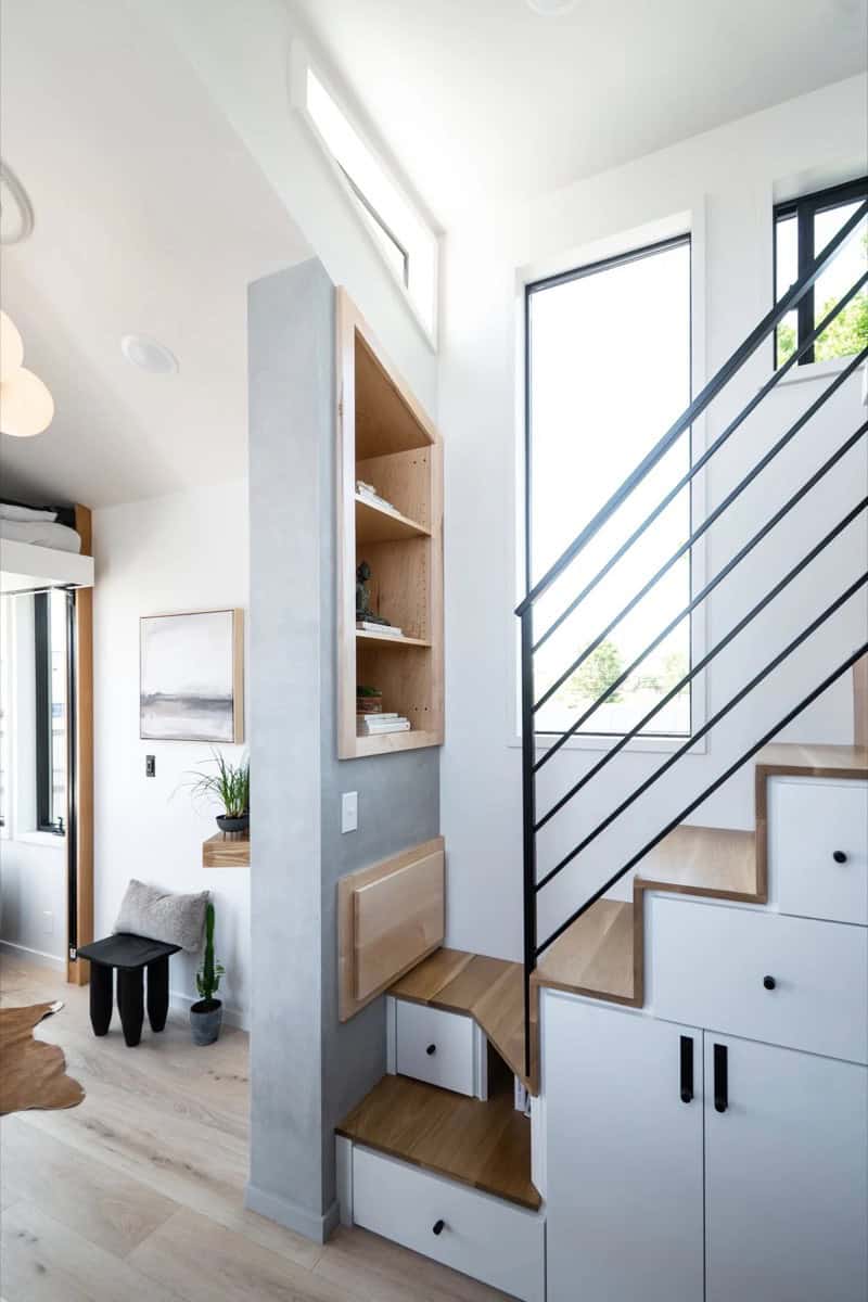 Staircase with built-in drawer and cabinet storage plus maple shelving in the Terra Urban tiny house