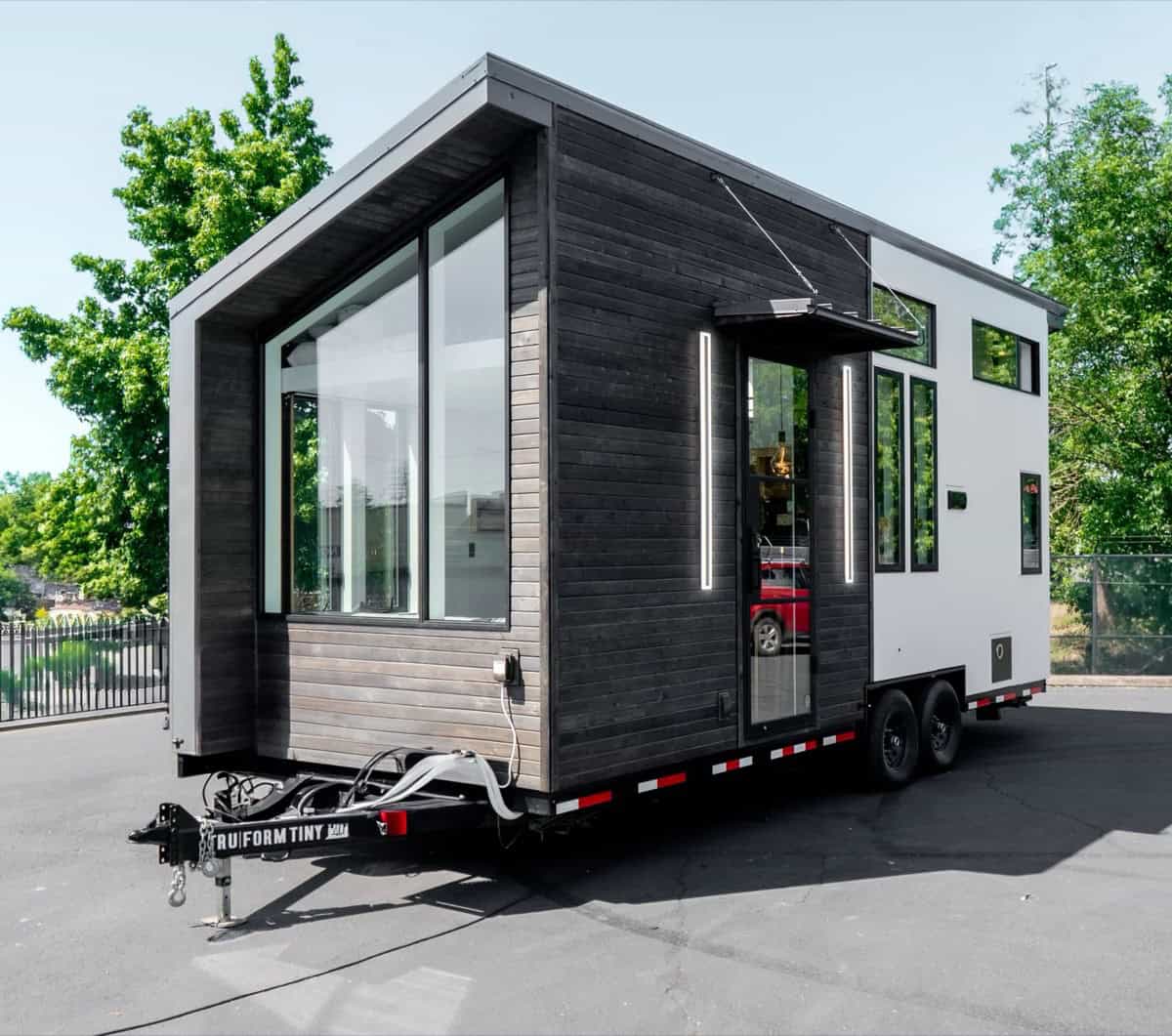 Terra Urban preowned tiny house on wheels by Tru Form Tiny with charred wood siding and a bold roofline