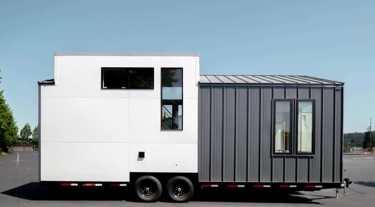 Gray metal-clad side of the Terra Urban tiny house with raised loft box and large windows