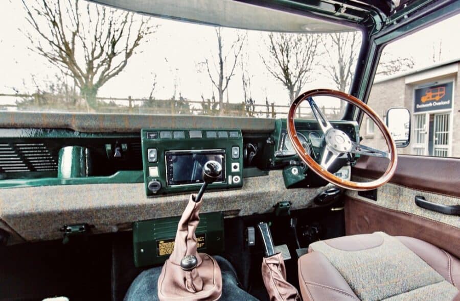 Land Rover motorhome dashboard with steering wheel and controls.