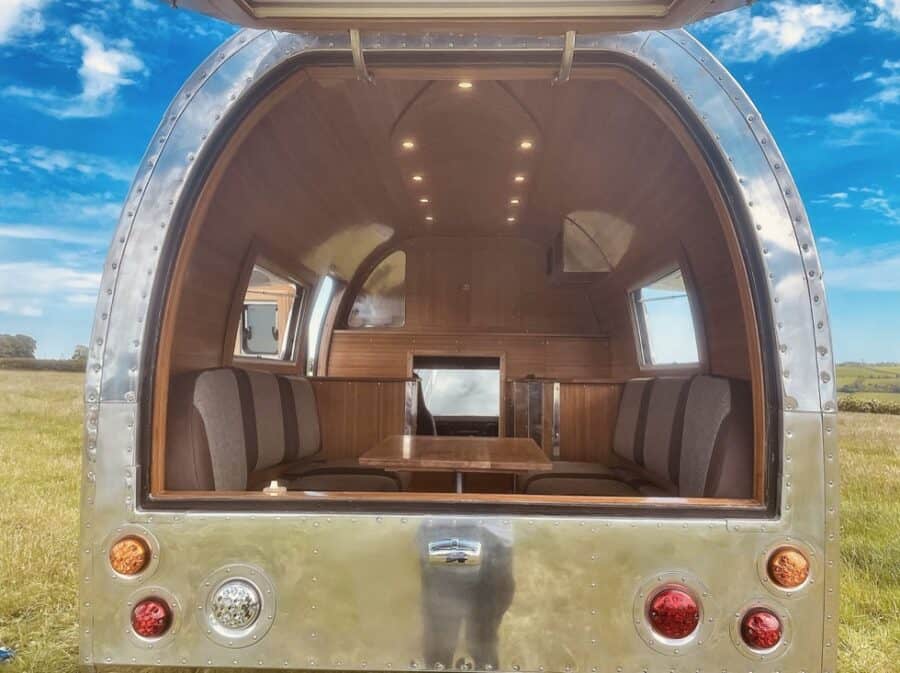 Classic Land Rover Motorhome Interior with Wooden Accents and Cozy Seating.