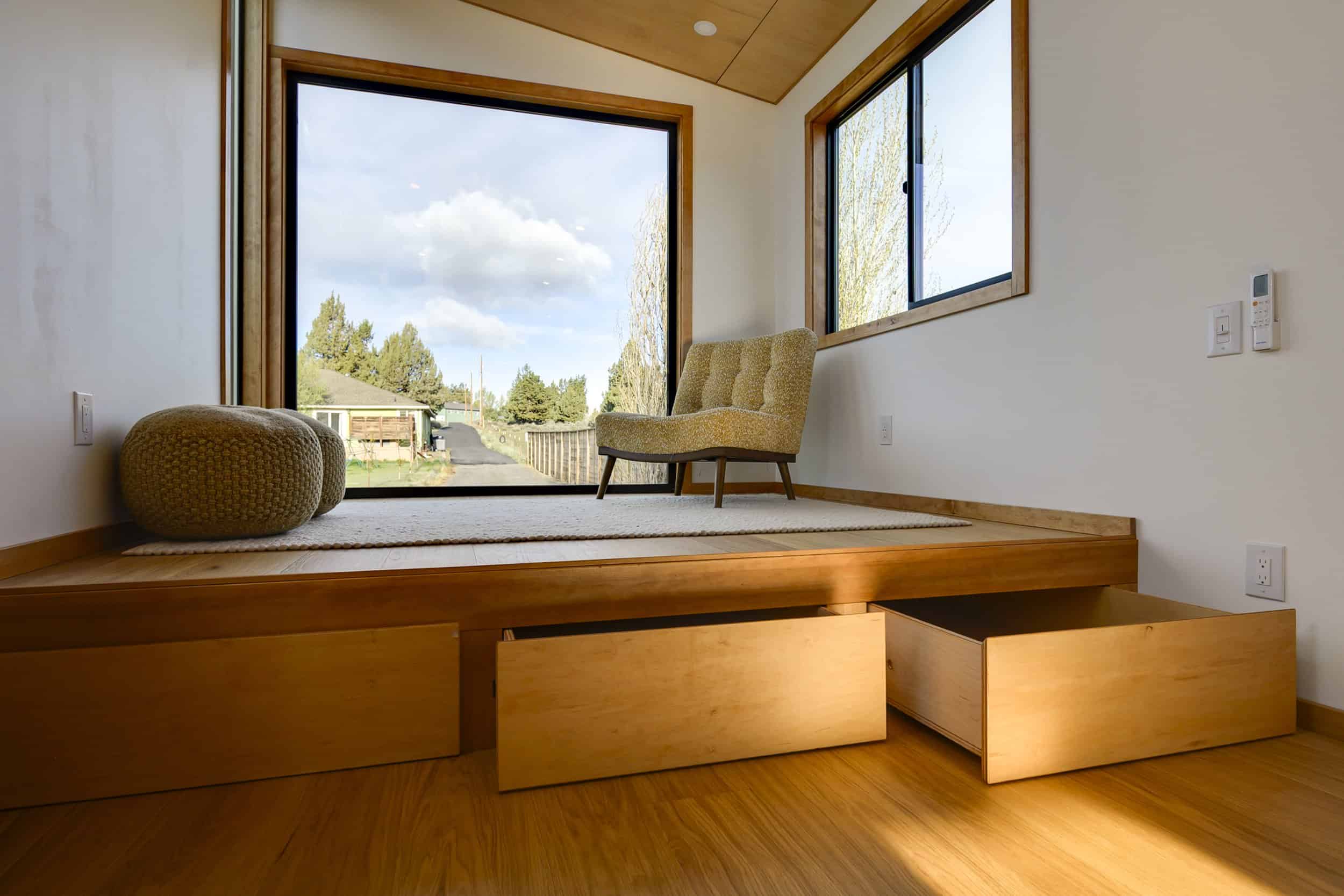 Massive eight-foot-deep storage drawers pulling out from beneath the raised platform in the Black Butte tiny house