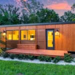 Modern tiny house featuring a spacious first-floor bedroom in a sleek, wooden design.