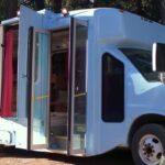 Custom tiny home built inside a shuttle bus for compact living and travel.