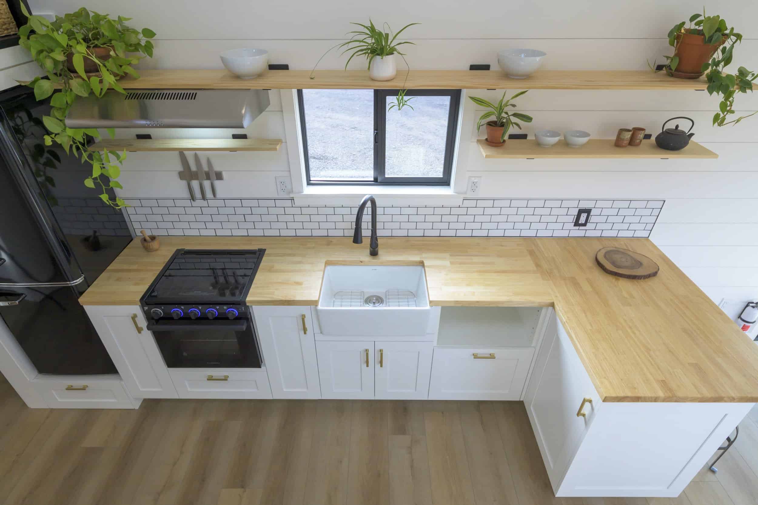 Overhead view of the Ochoco kitchen showing the gas range, farmhouse sink, and wraparound butcher block counters