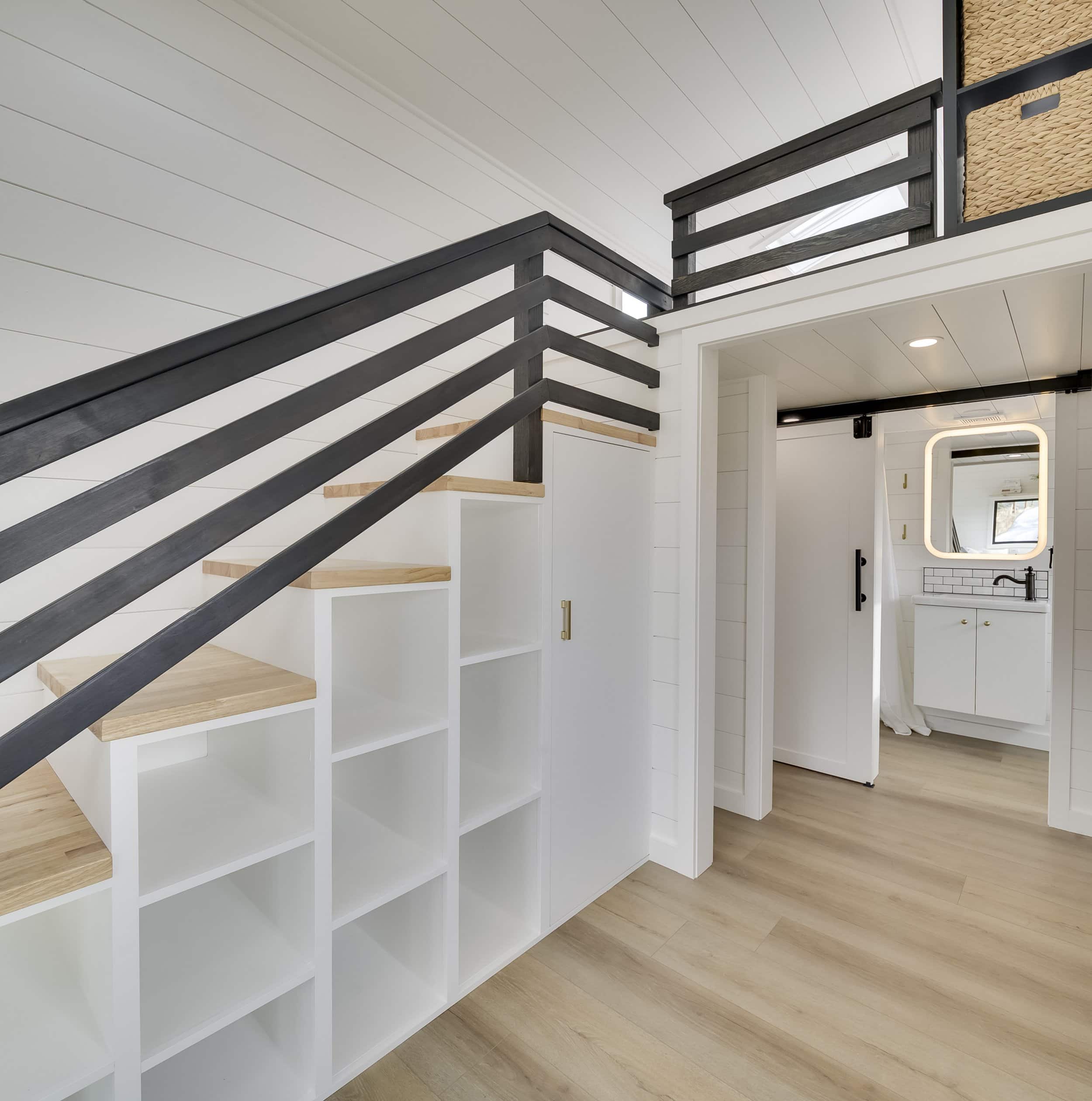 The Ochoco open-tread storage staircase with built-in cubbies leading to the loft, with the bathroom beyond