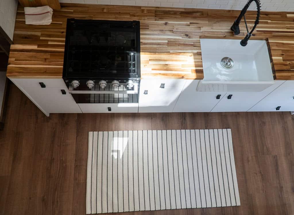 Overhead view of the Olympic kitchen showing the gas range, farmhouse sink, and acacia counters