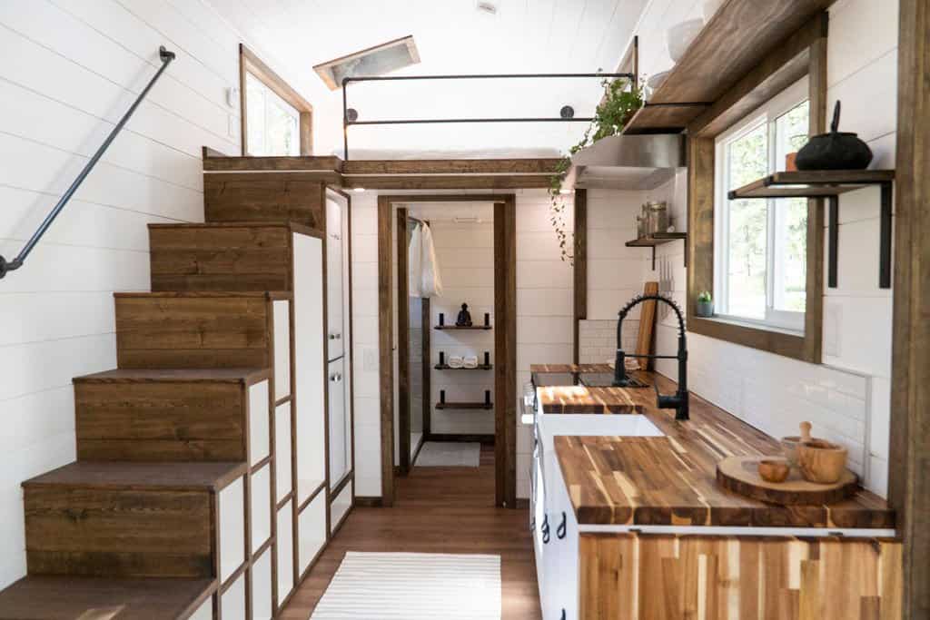 The Olympic storage staircase that conceals the refrigerator and leads up to the loft, with the bathroom beyond