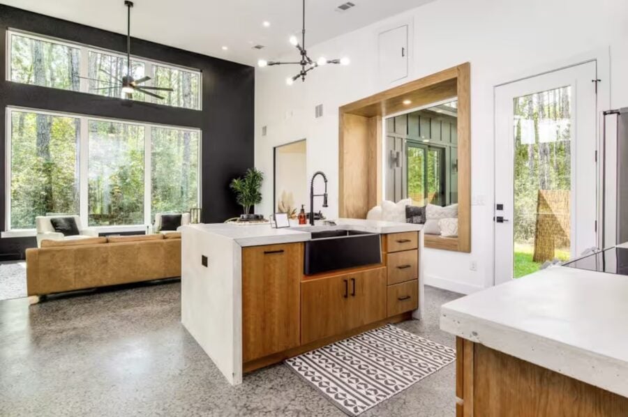 Bright, modern pine house interior with open living space and large windows in Florida.