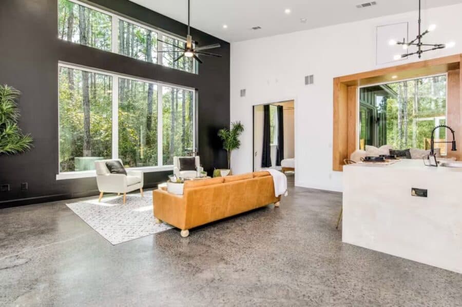 Bright modern interior of Pine House cabin with large windows and minimalist decor in Florida.