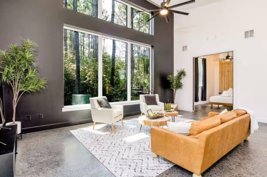 Bright living room with large windows and modern decor.