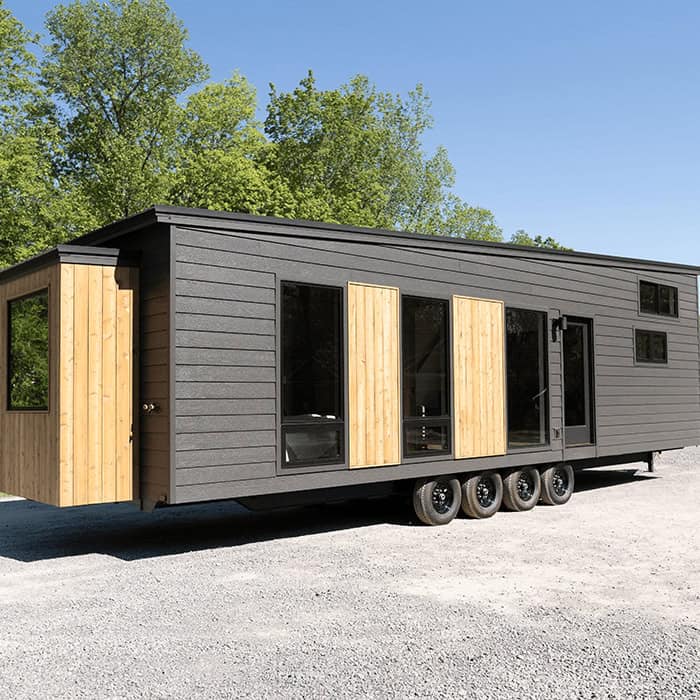 Tiny House on wheels with modern design and large windows.