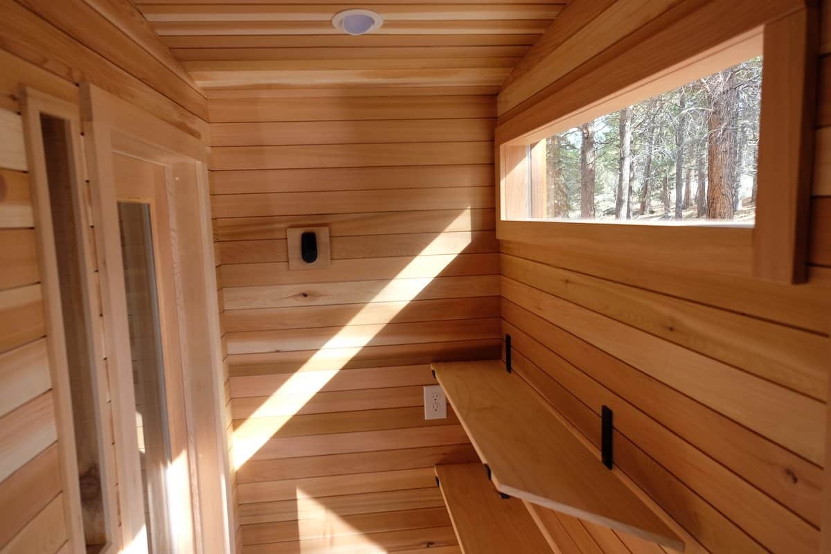 Cedar interior of the Silverado sauna with a window framing the surrounding forest