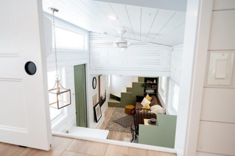 Interior view of a family of four's tiny home on wheels with modern decor and efficient space use.