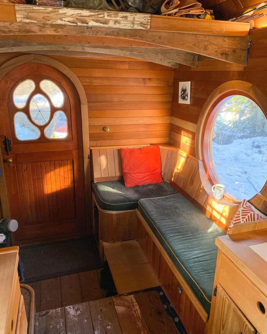 Charming tiny house with cedar shake exterior and warm wooden interior design.