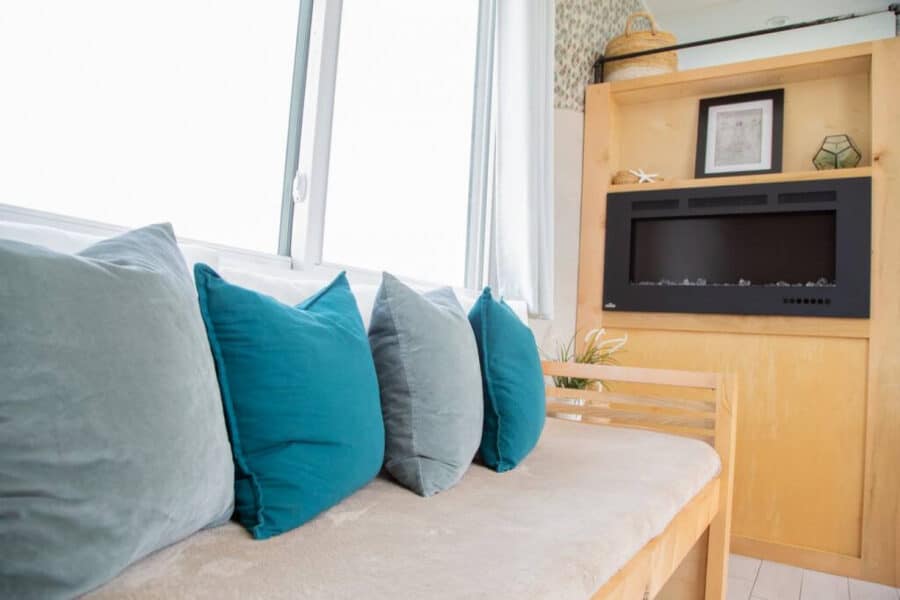 Cozy tiny house interior with comfortable sofa and lakefront view in Orlando, Florida.