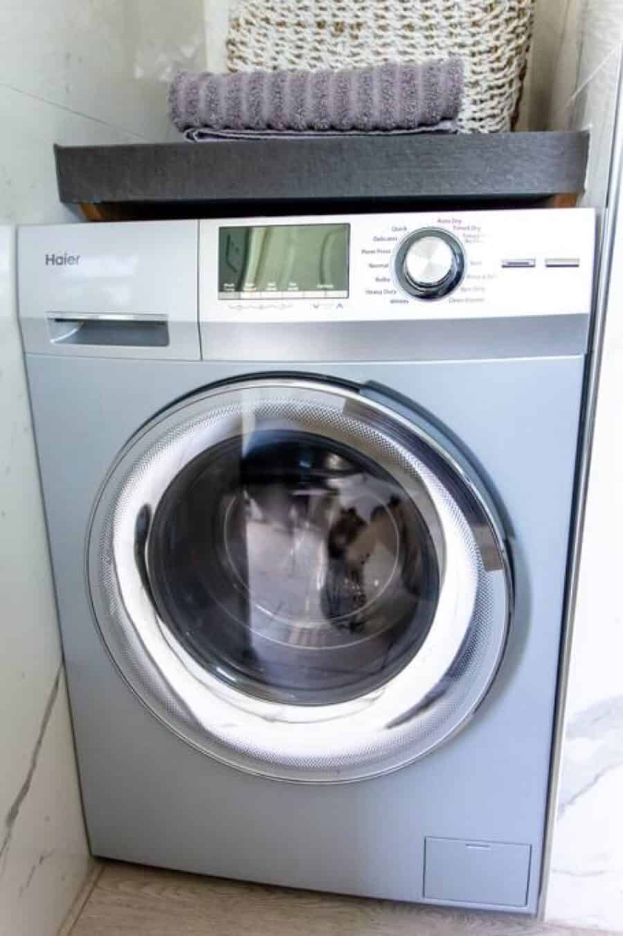 Compact washing machine in a tiny house laundry space in Orlando, Florida.