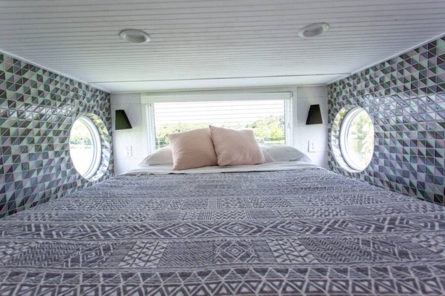 Cozy tiny house bedroom with modern decor and scenic lake views in Orlando, Florida.