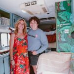 Inside a renovated 24-year-old truck camper with vibrant decor and cozy living space.