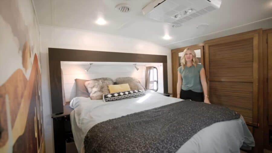 Interior of a tiny bedroom with a large bed and wooden accents, showcasing small space living.