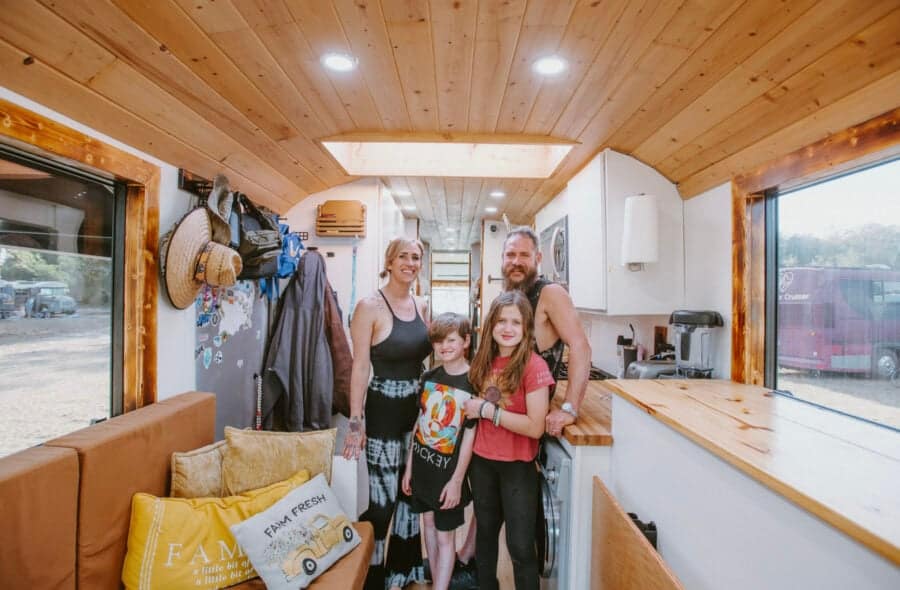 Family enjoying their tiny house with kids' bunk room and cozy interior.