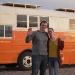 Skoolie bus converted into a tiny home with two offices and a spacious pantry.