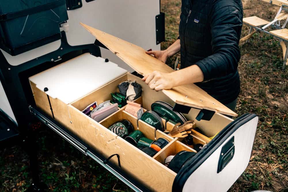 Compact storage drawer in tiny house for tools and supplies.