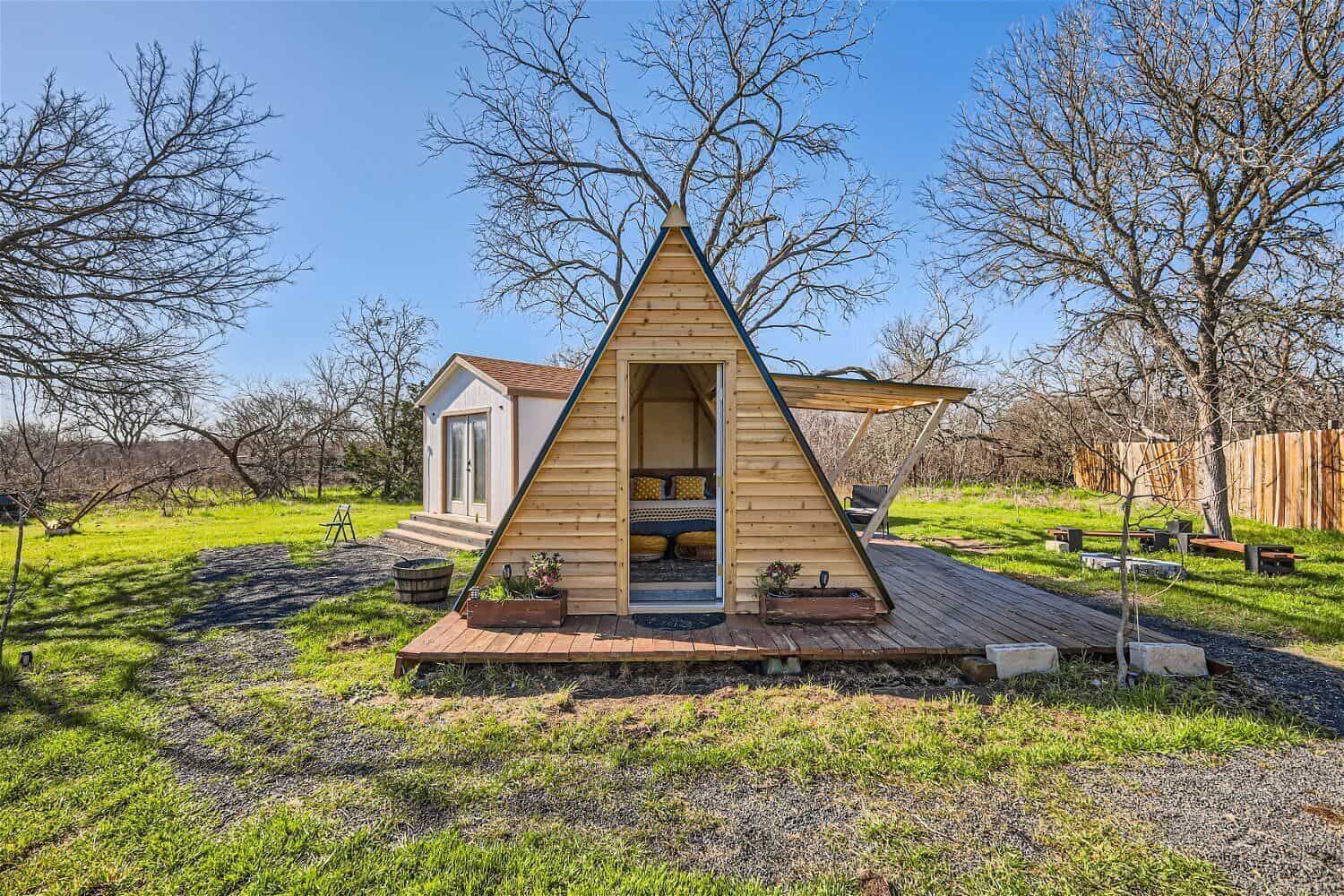 Tiny A-frame cabin on 5 acres near Austin Texas with wood cladding and green countryside