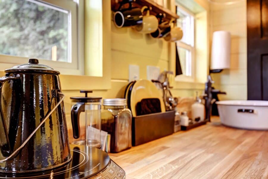 Butcher block kitchen counter with induction burner and percolator in the Arthur tiny house