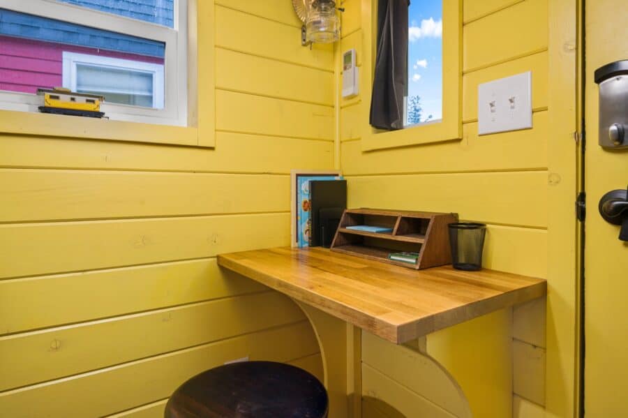 Small desk nook by the front door of the Arthur train car tiny house