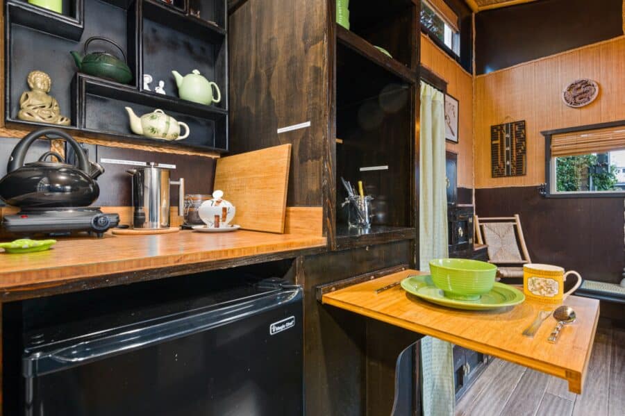 Kitchenette and fold-down table in the Bamboo tiny house