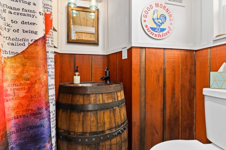 Whiskey barrel vanity in the bathroom of the Barn tiny house
