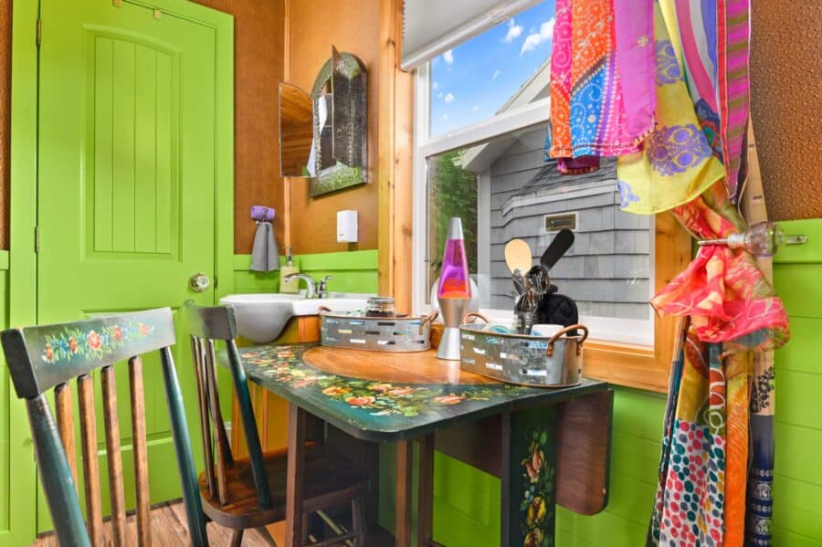 Hand-painted dining table and lava lamp in the Boho Wagon tiny house