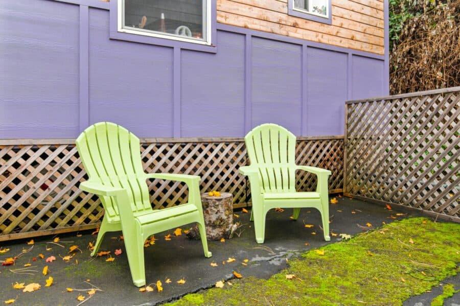 Lime green Adirondack chairs on the patio of the Boho Wagon tiny house