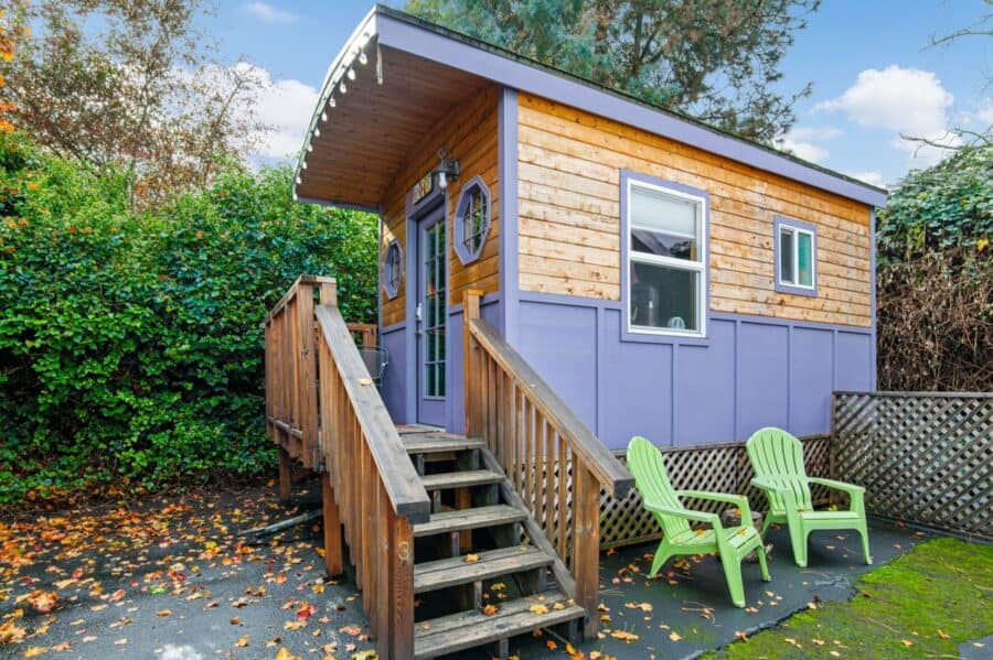 Side view of the purple and cedar Boho Wagon tiny house at Tiny Digs