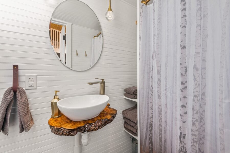 Finlandia tiny house bathroom with a vessel sink on a live-edge wood vanity