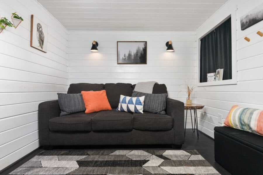 Sofa and living area inside the Finlandia tiny house at Tiny Digs
