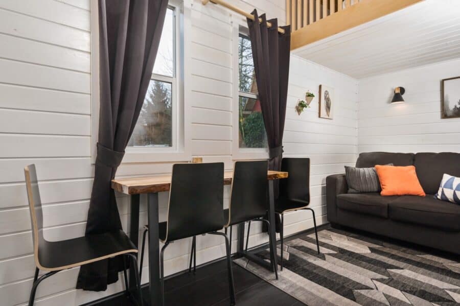 Dining counter with black chairs under the windows of the Finlandia tiny house