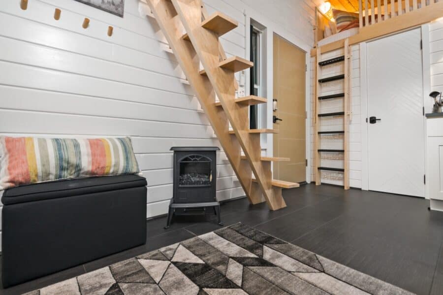 Floating maple staircase and electric stove inside the Finlandia tiny house