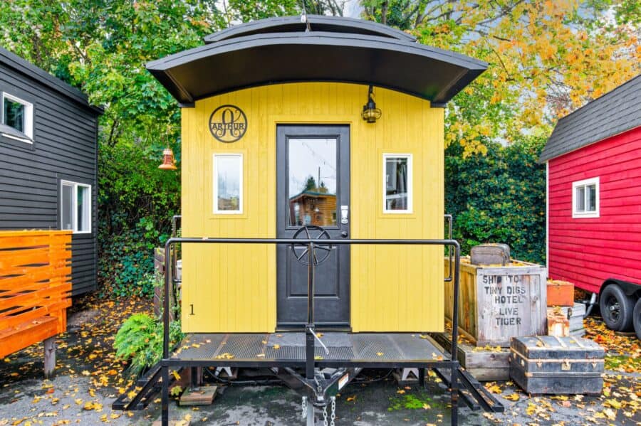 The Arthur train car tiny house between the Finlandia and the Barn at Tiny Digs Hotel in Portland